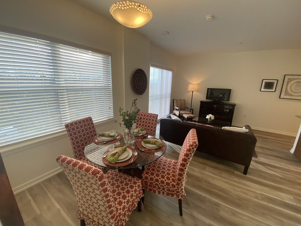 a dining room and living room with a table and chairs