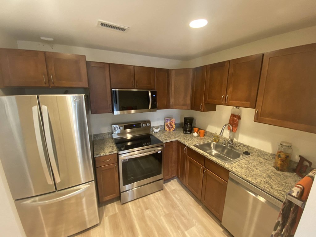 a kitchen with stainless steel appliances and wooden cabinets