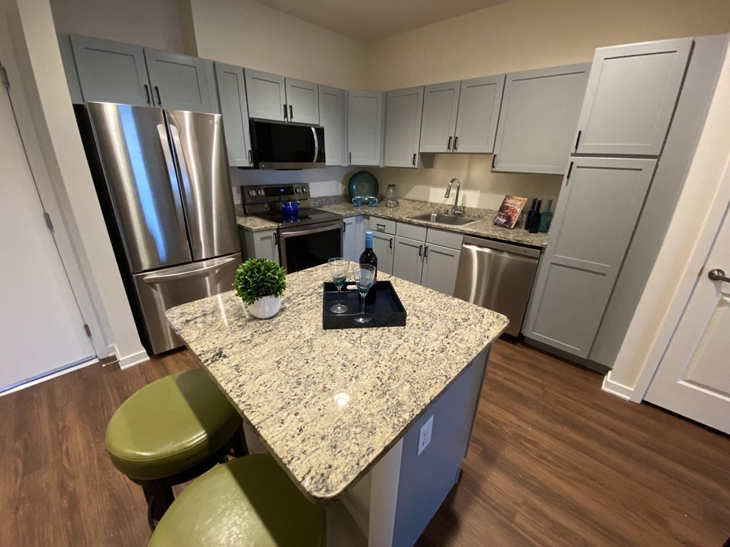 a kitchen with stainless steel appliances and a granite counter top