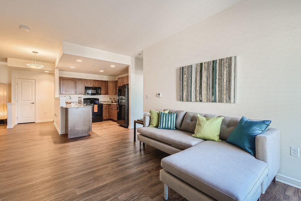 a living room with a couch and a kitchen
