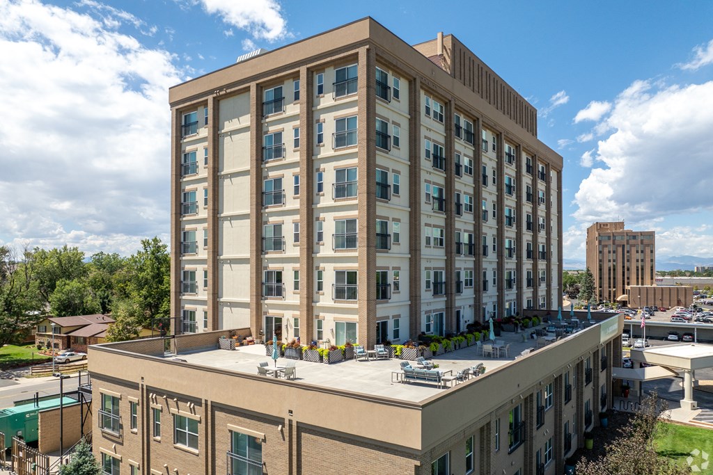 Apartment building exterior with large rooftop terrace