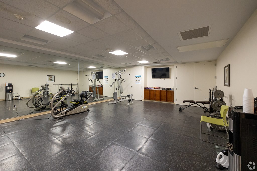 a gym with exercise bikes and other equipment on the floor