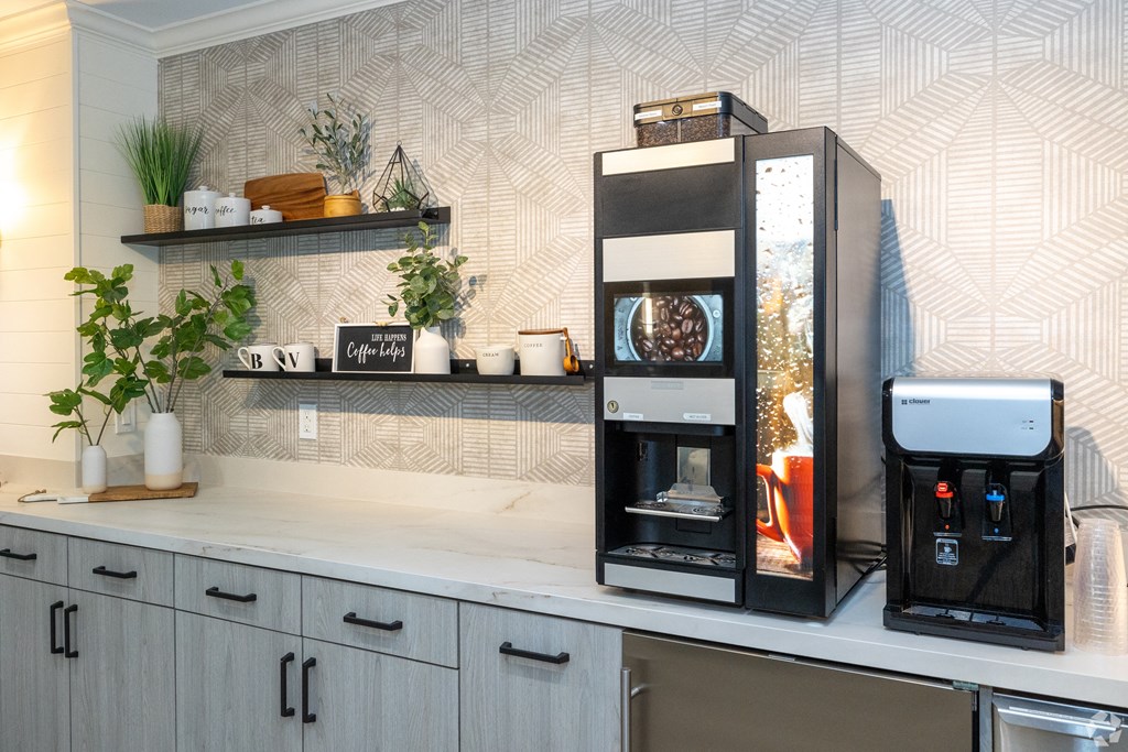 a kitchen with an espresso machine and a coffee maker on a counter