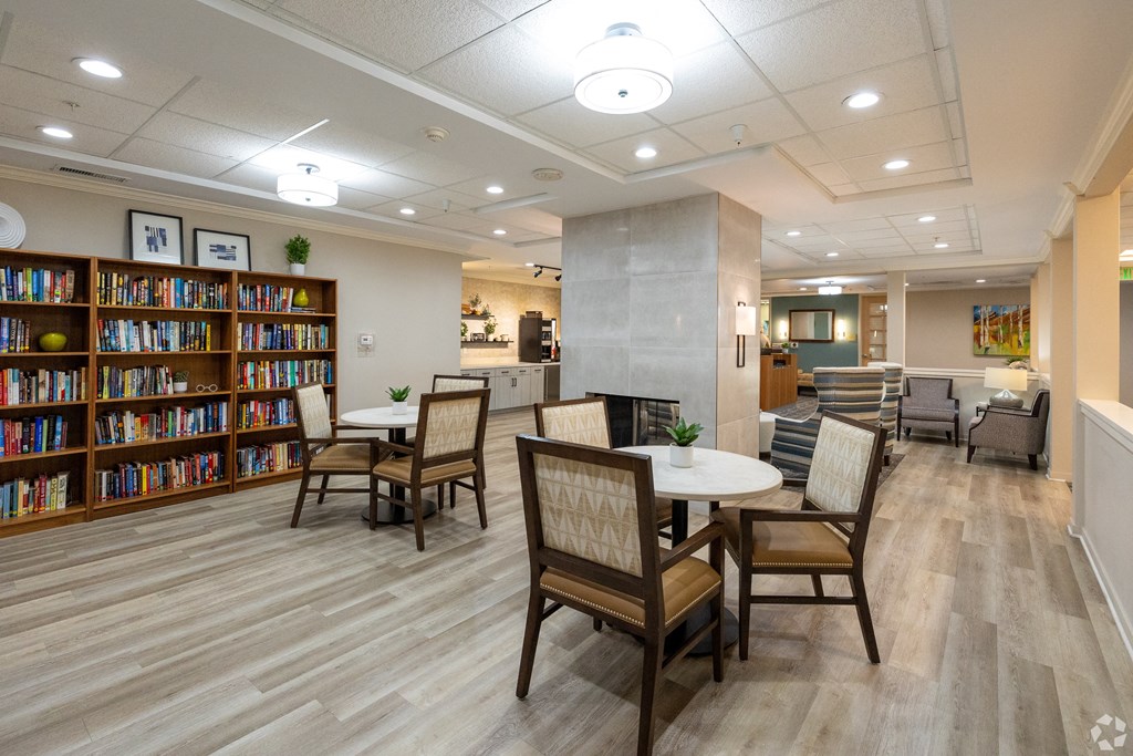 Library with tables chairs and fireplace