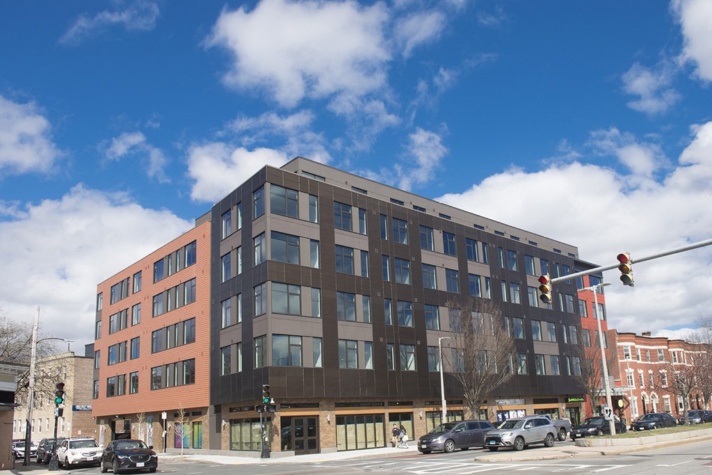 a large brown building on the corner of a city street