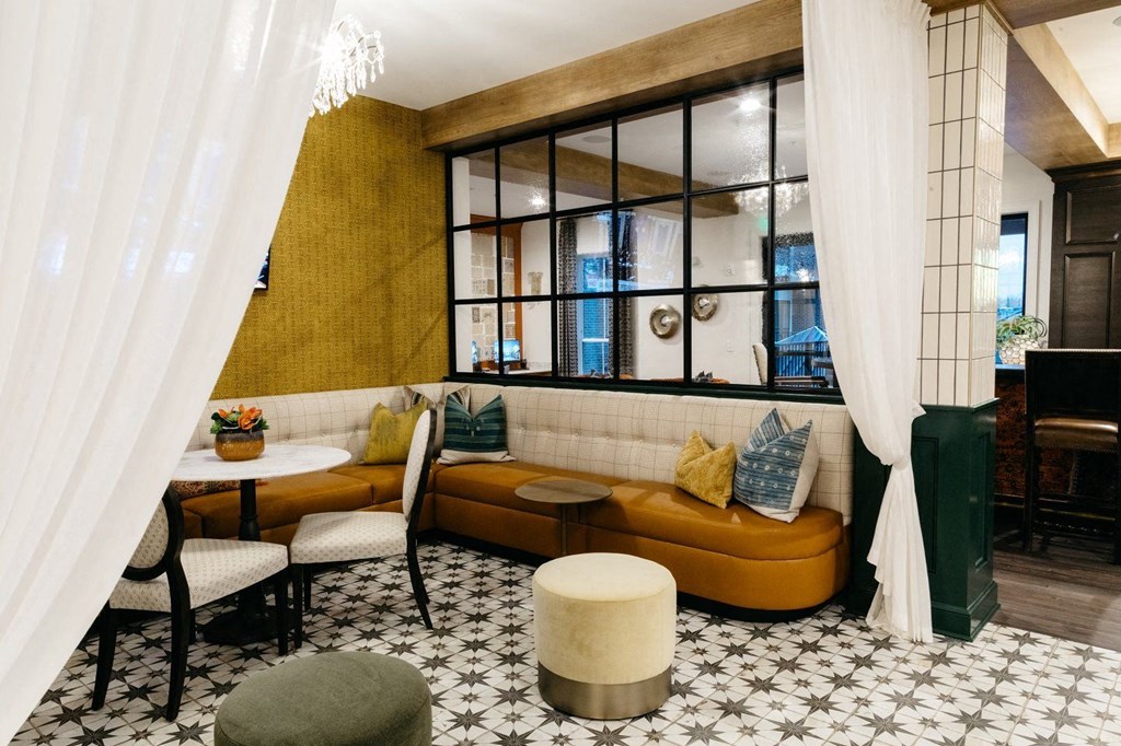 a living room with a couch and a table in front of a window