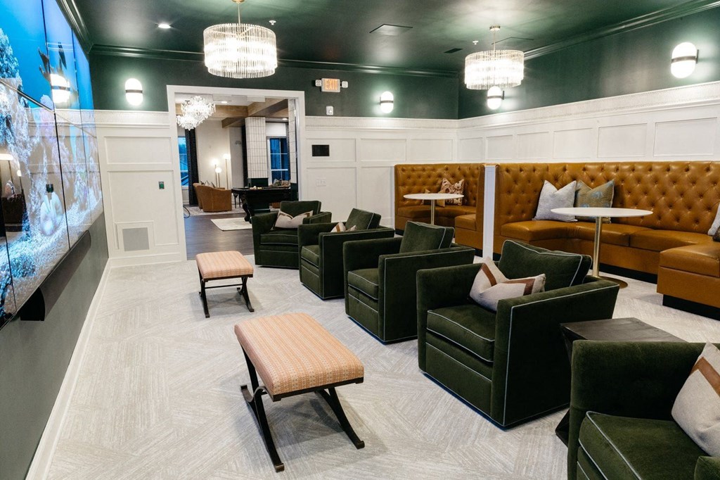 a lounge area with couches and chairs and tables