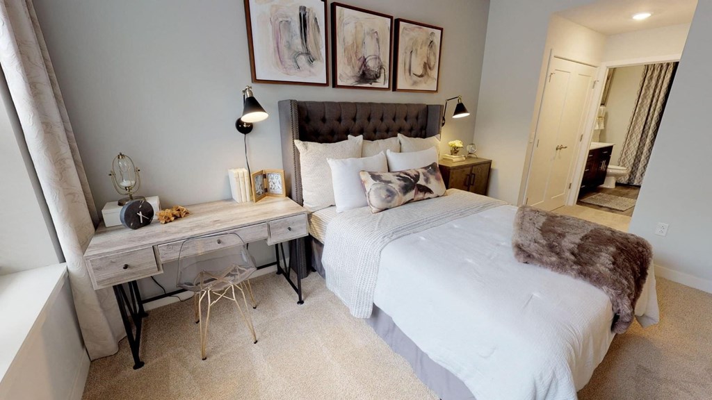 a bedroom with a bed and a desk