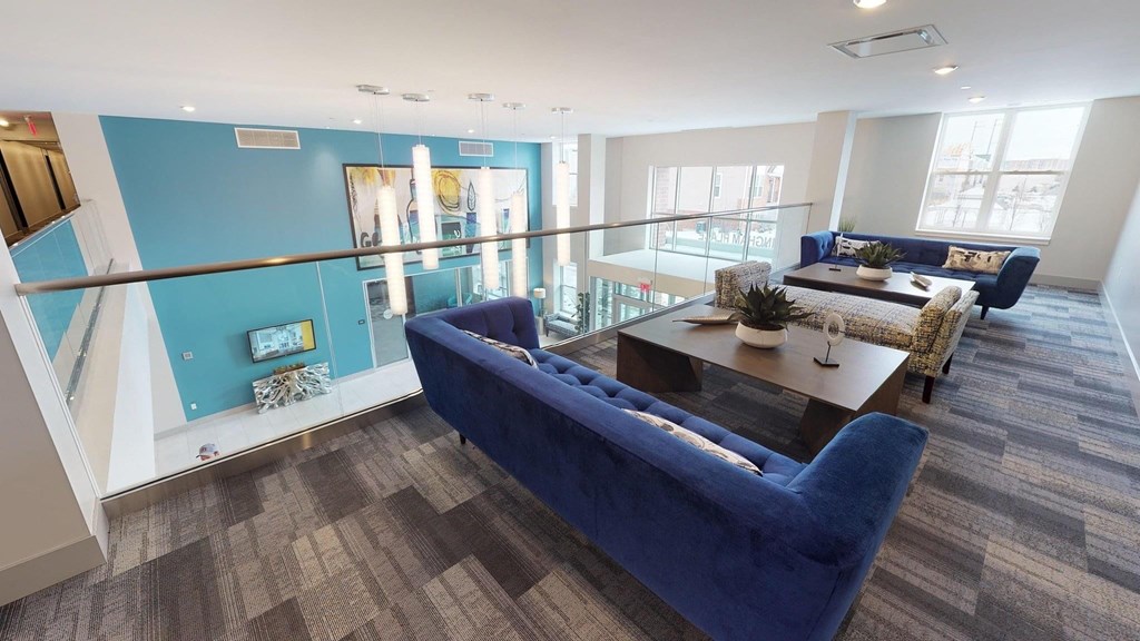 a living room with a blue couch and a table
