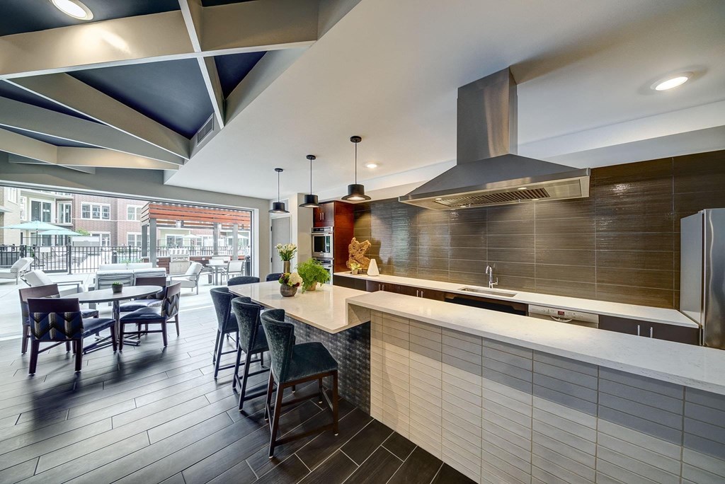 a kitchen with a long counter and a table with chairs