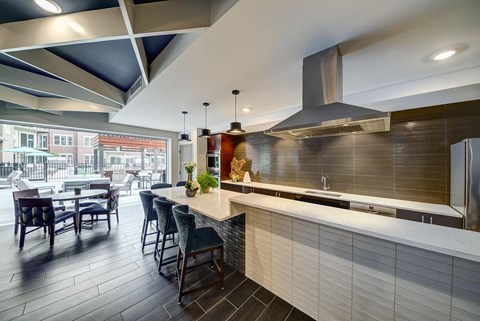 a kitchen with a long counter and a table with chairs