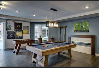 a games room with a pool table and a television