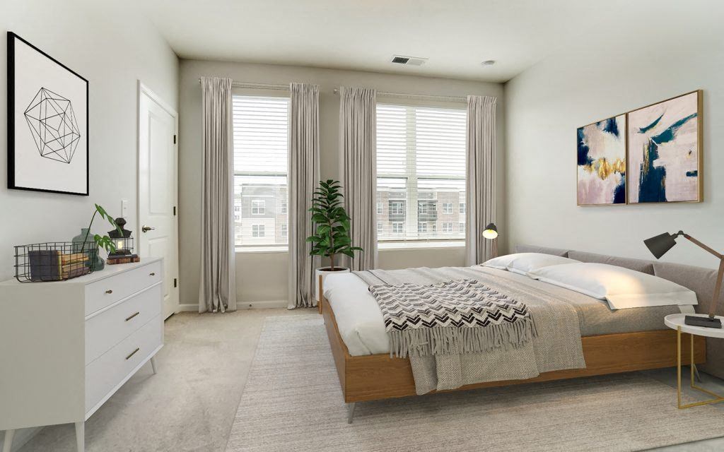 a bedroom with a bed and two windows