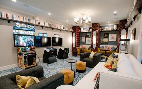 a living room filled with furniture and a video game