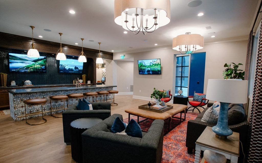 a living room filled with furniture and a bar