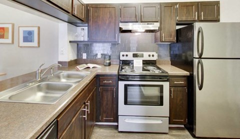 a kitchen with stainless steel appliances and wooden cabinets
