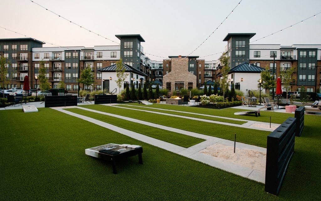 a park with lawns and buildings in the background