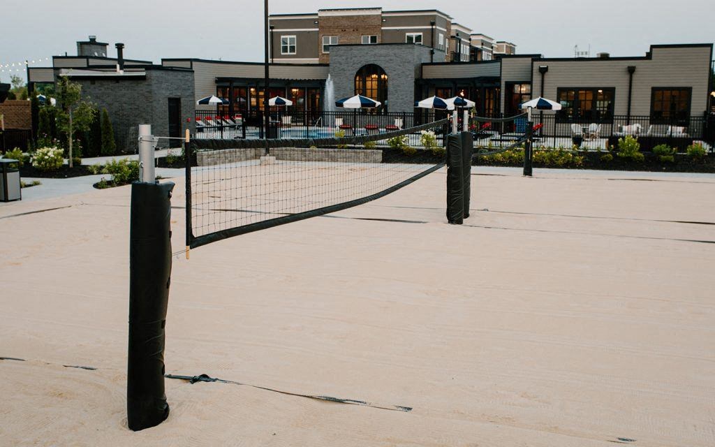 a tennis court with a building in the background