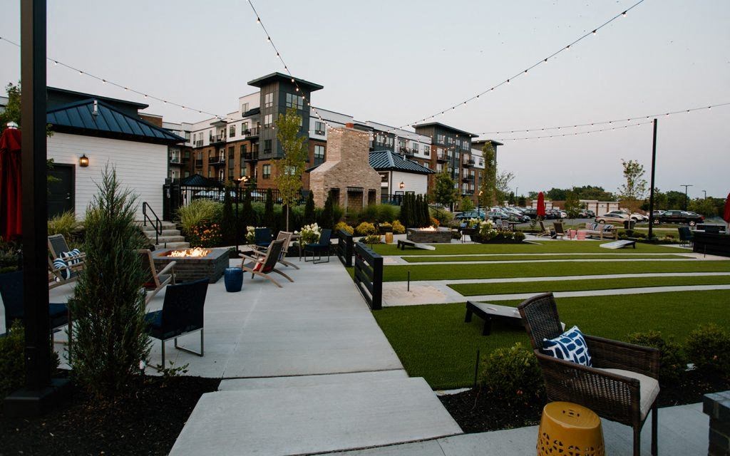 a patio with tables and chairs in a park