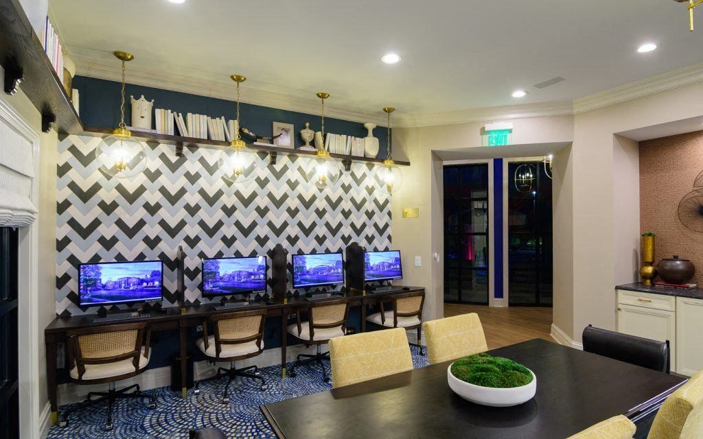a conference room with four computers on a table