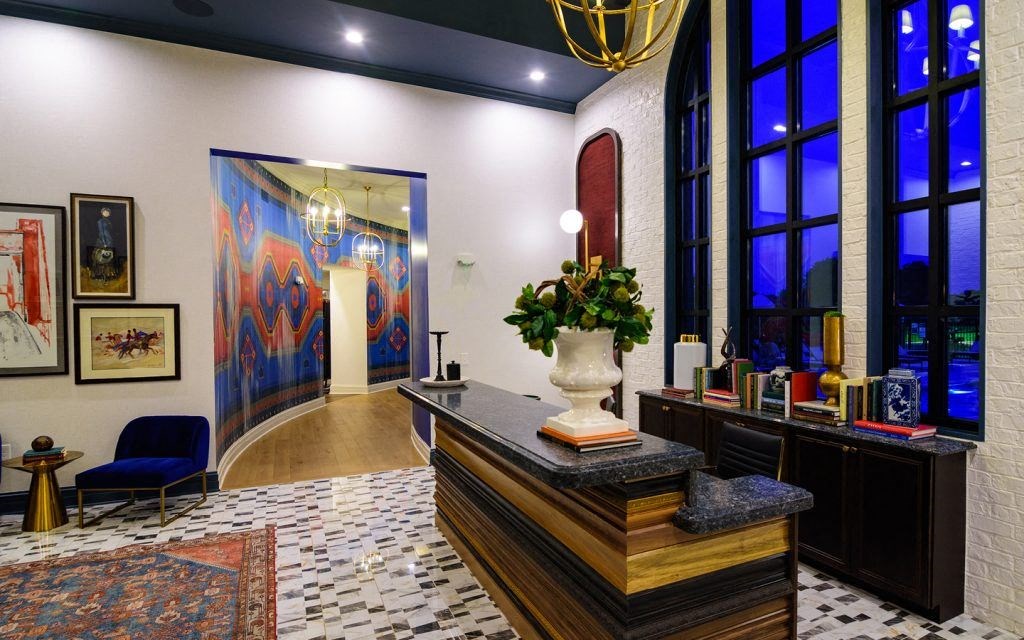 the lobby or reception area of a hotel with large windows