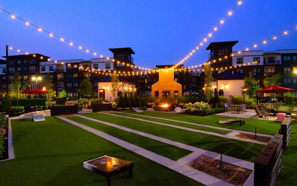 the courtyard at night is lit up with string lights