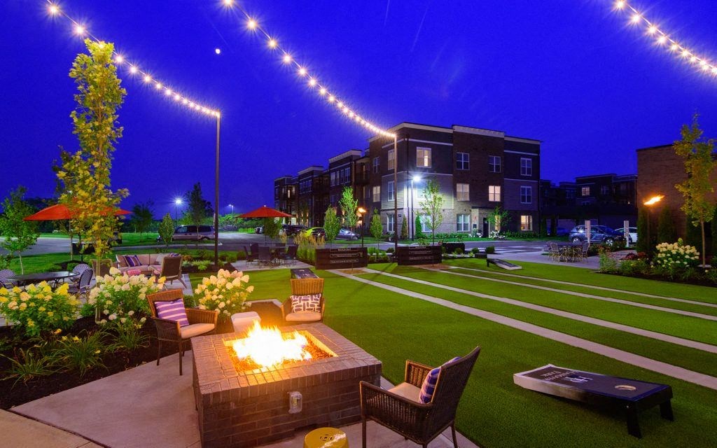 a patio with a fire pit at night