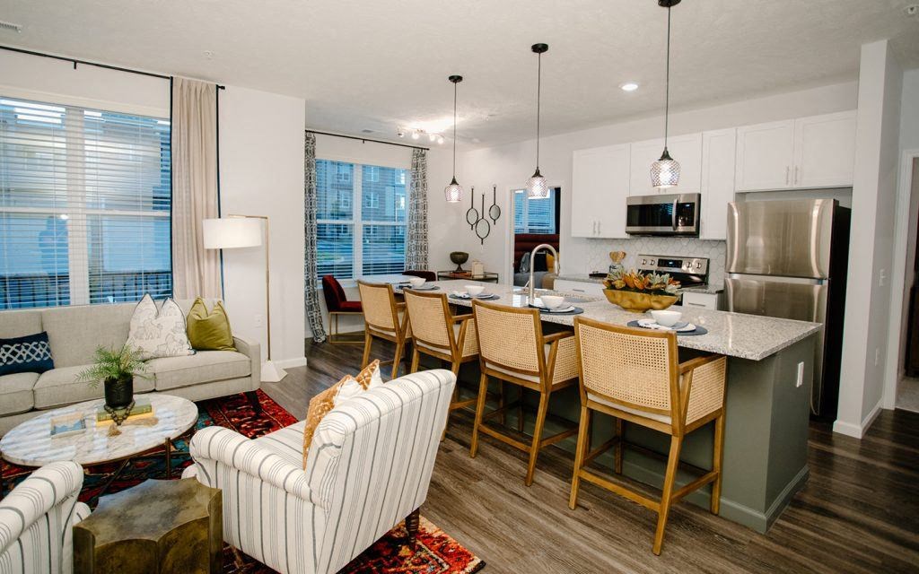 a kitchen and living room with a table and chairs
