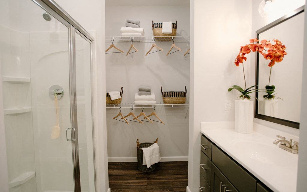 a bathroom with a shower and a sink and a mirror