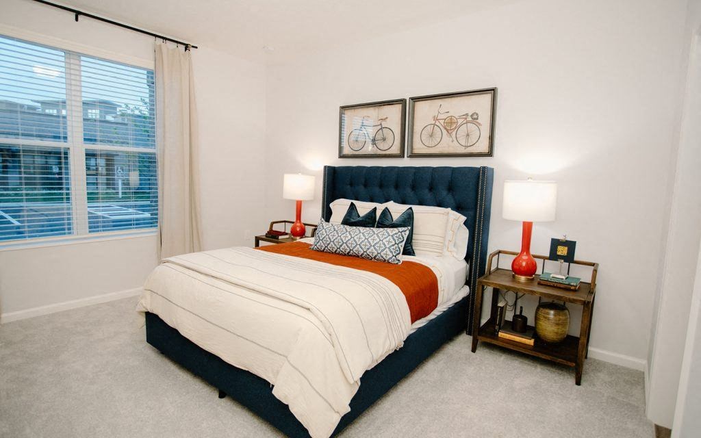 a bedroom with a bed and a large window