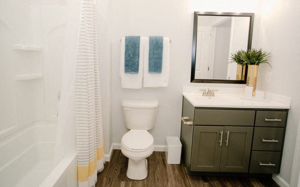 a bathroom with a white toilet and a sink