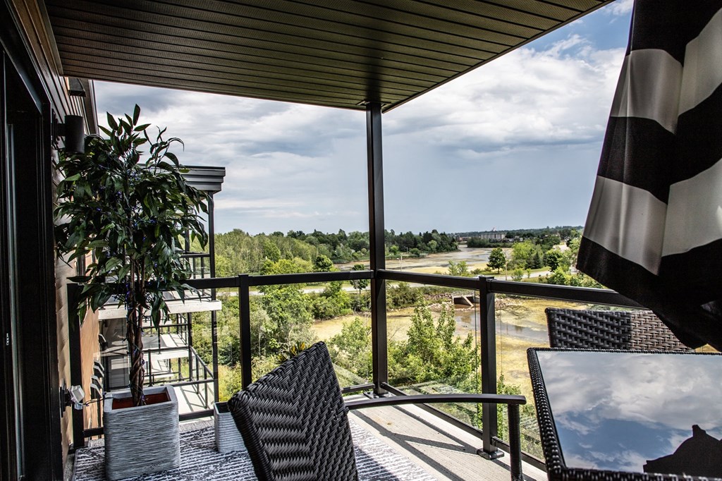 a balcony with a view of a field and trees
