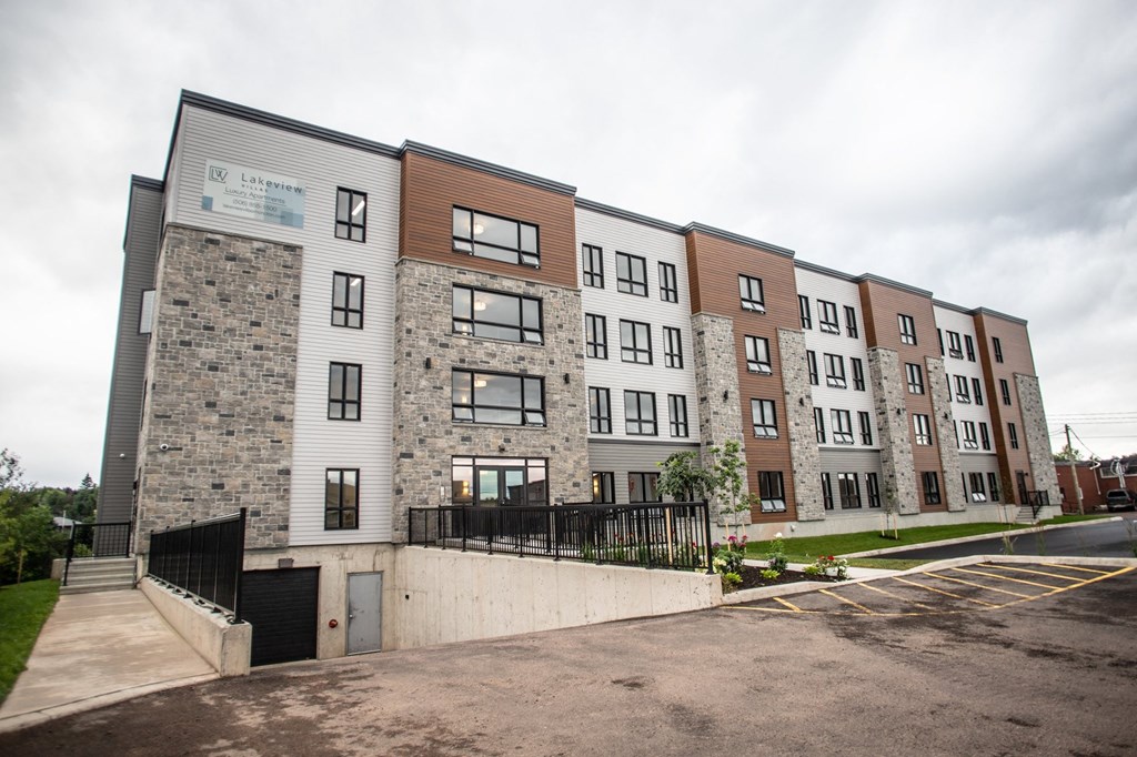 a rendering of a new apartment building on a city street