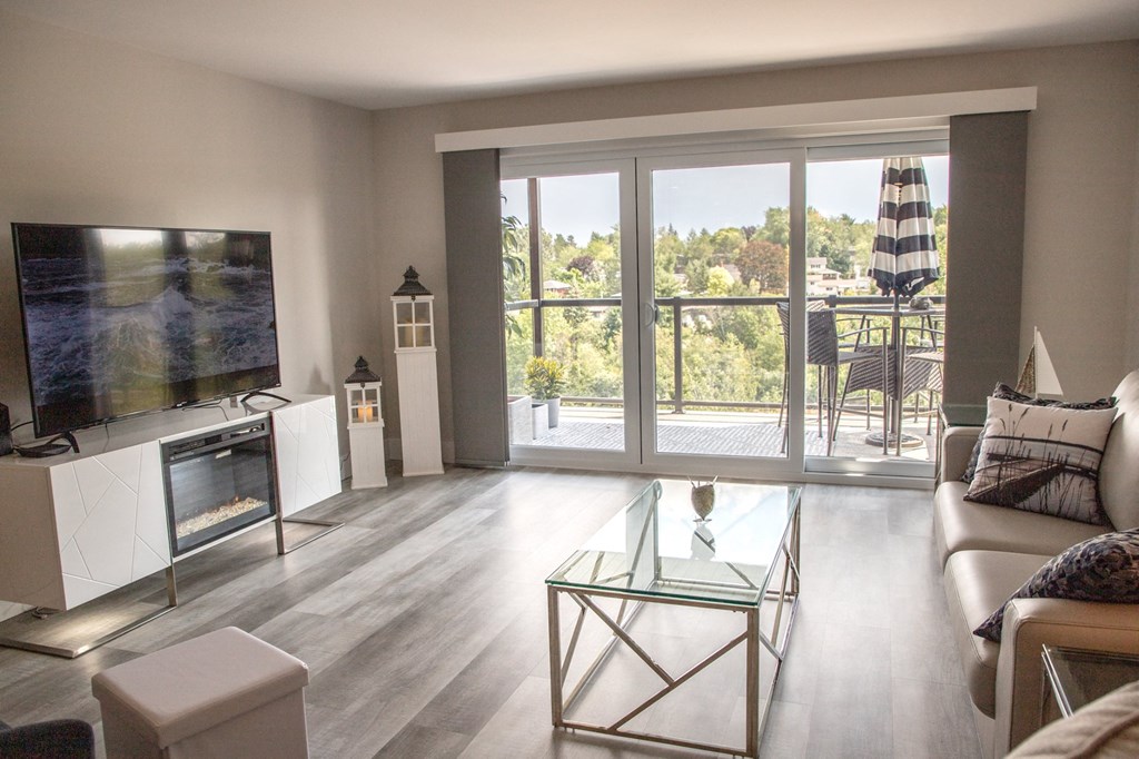 a living room with a bunch of glass windows