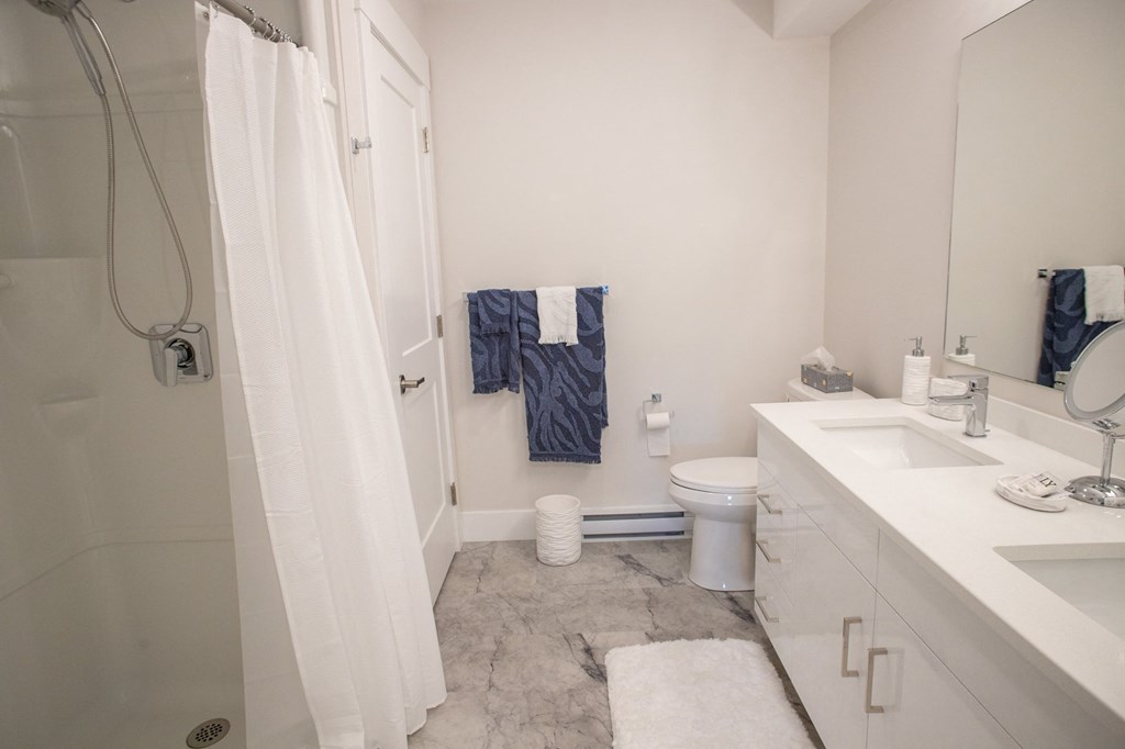 a small bathroom with a shower toilet and sink