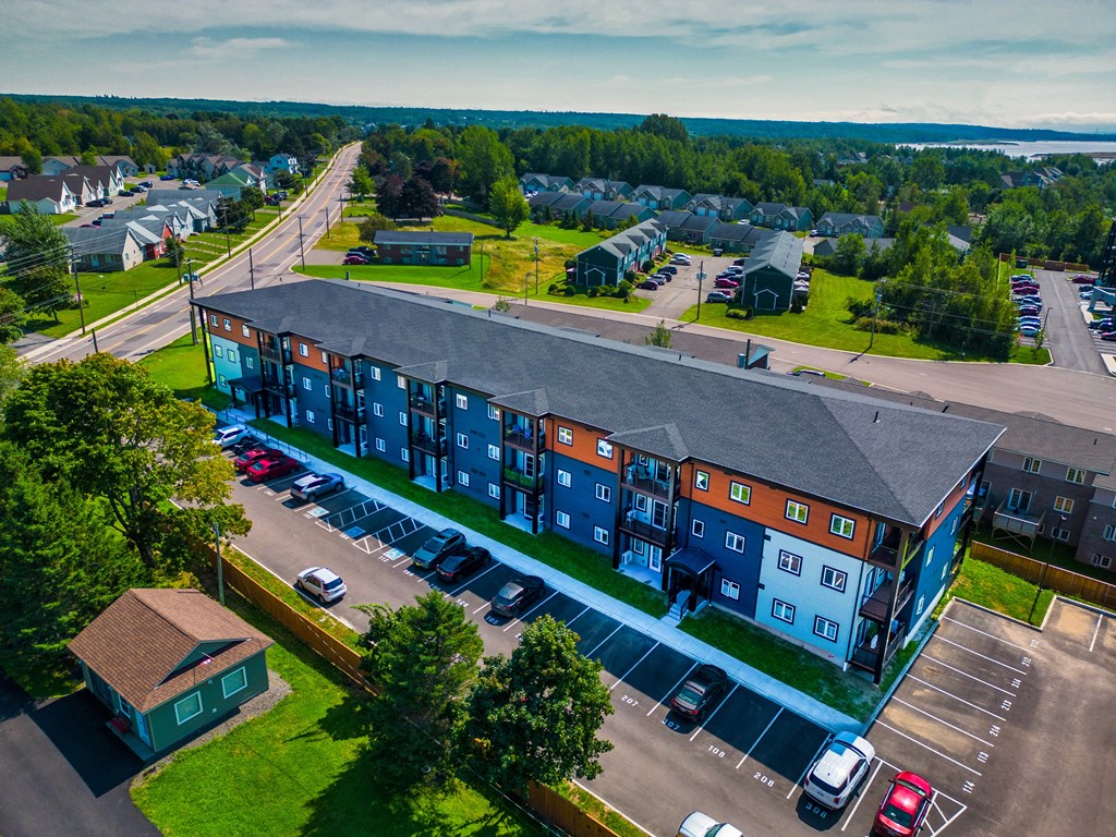 an aerial view of an apartment building on a city street