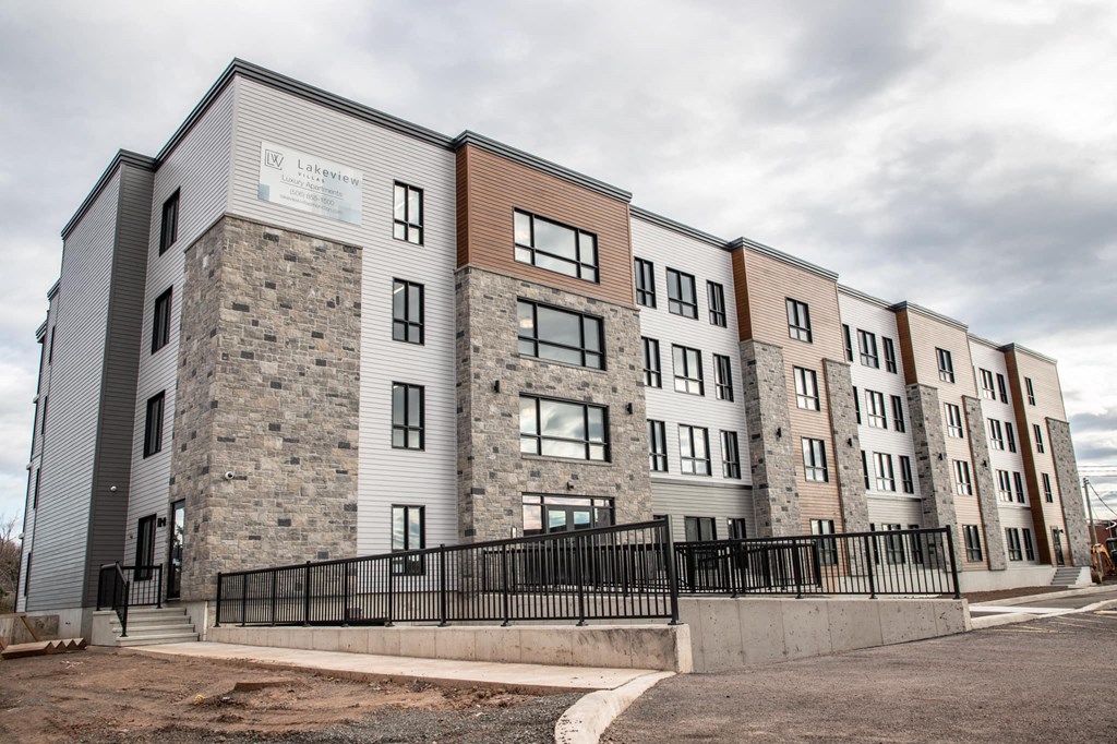a large apartment building with a fence in front of it