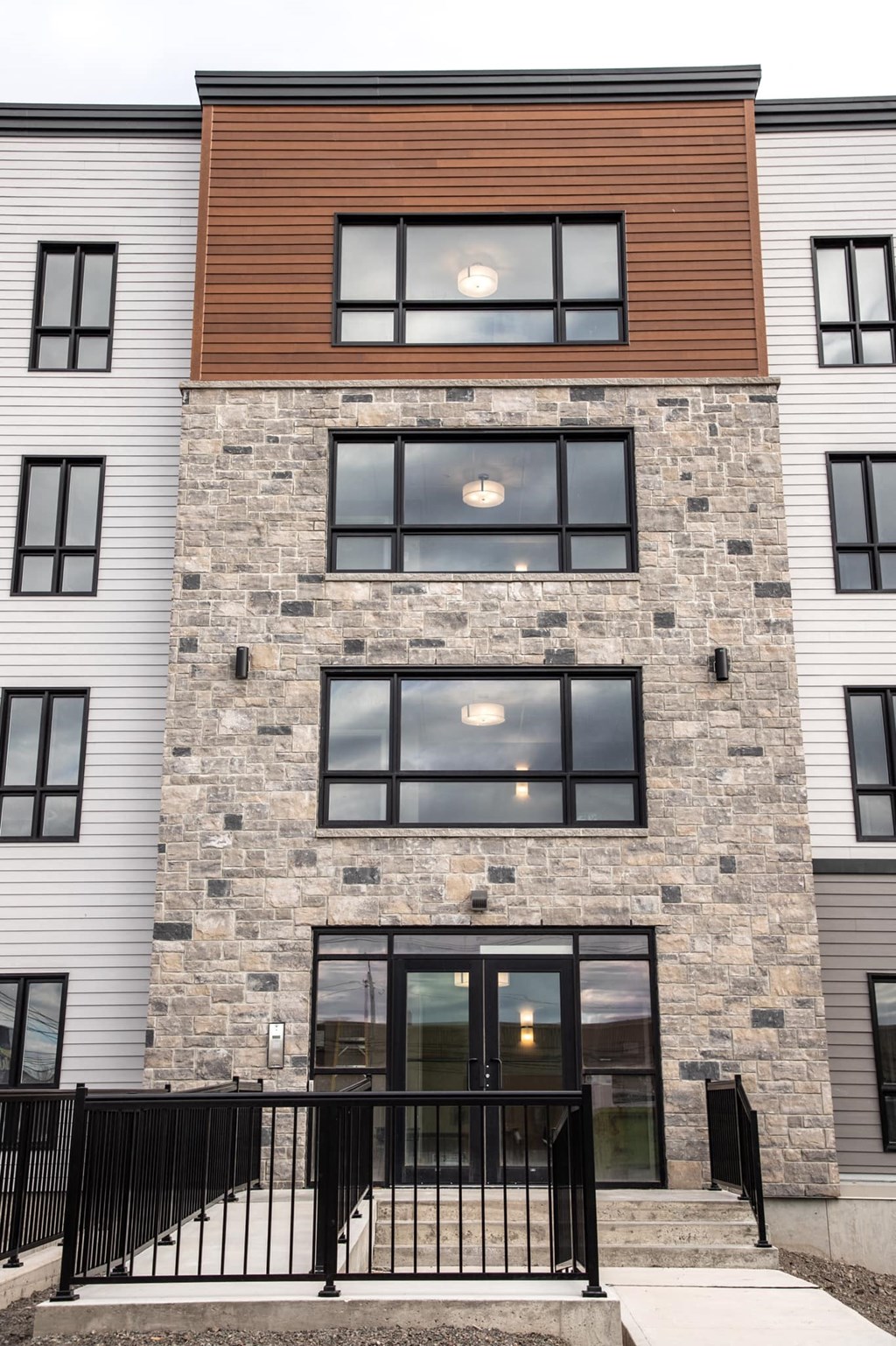 the front of a condo building with a glass door