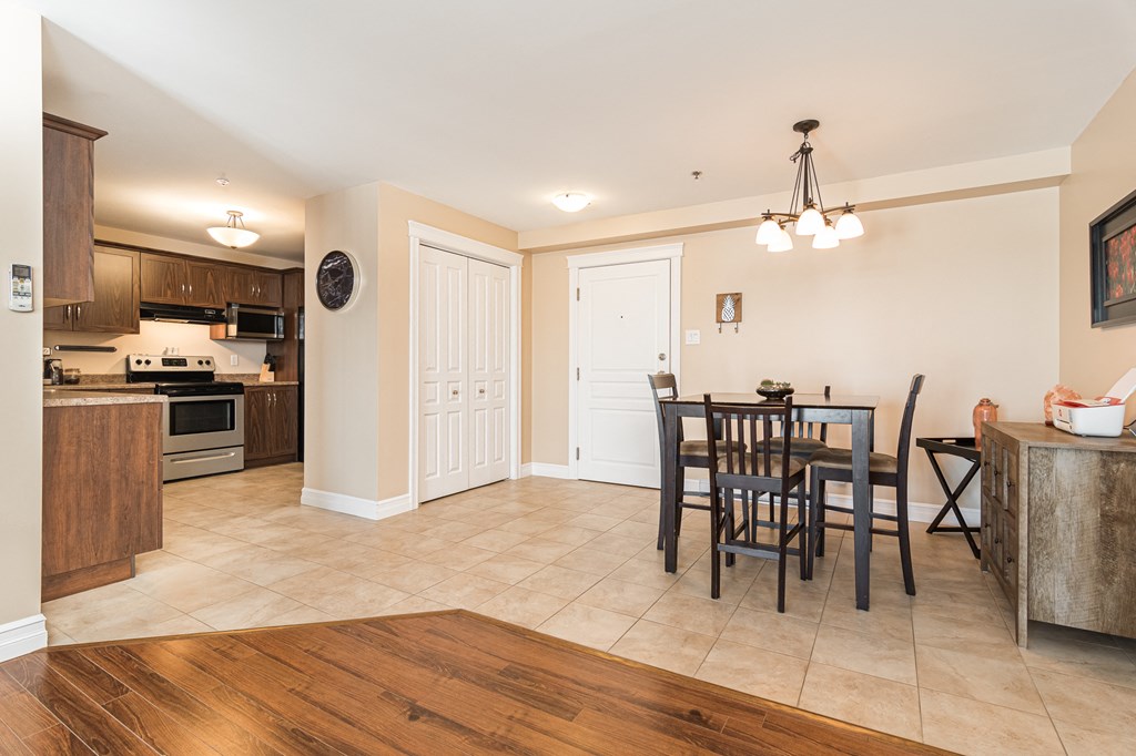 a dining room and kitchen with a table and chairs