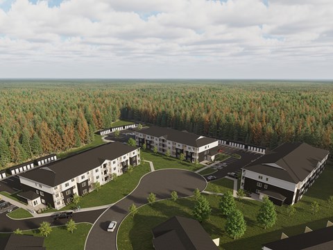 A large building complex surrounded by trees.