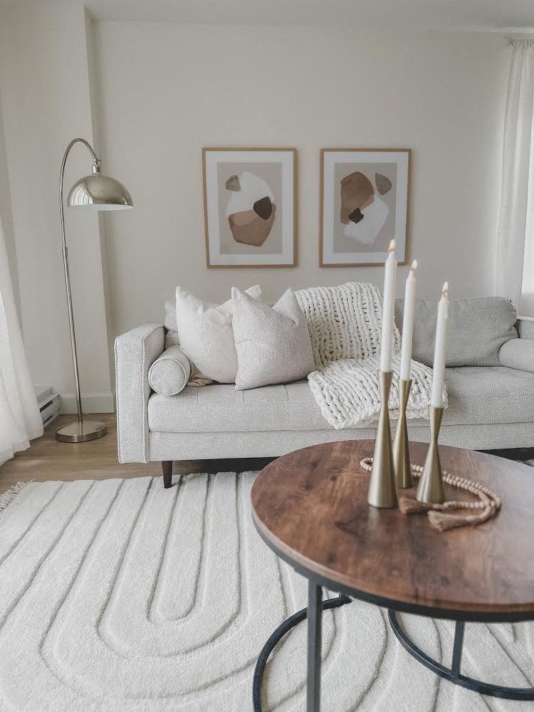 a living room with a couch and a table with candles