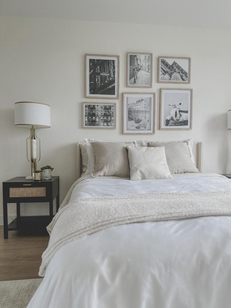 a bedroom with a bed and pictures on the wall