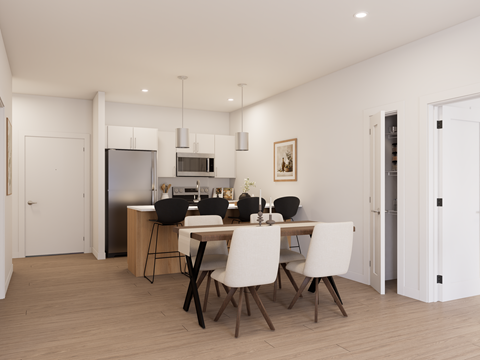 A modern kitchen with a dining table set for four.
