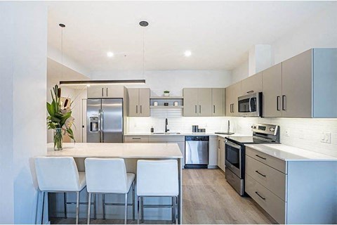 a large kitchen with a table and chairs