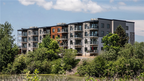 an apartment building on the side of a river