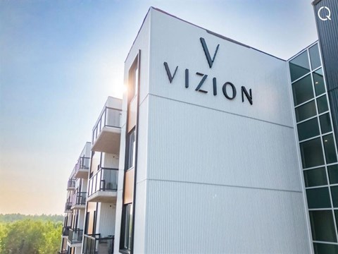 the facade of a building with the vixon logo on it