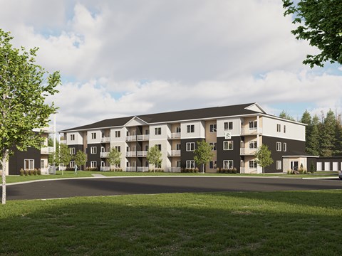 A large apartment complex with a grassy area in front.