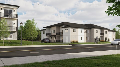 A modern apartment complex with a car parked in front.