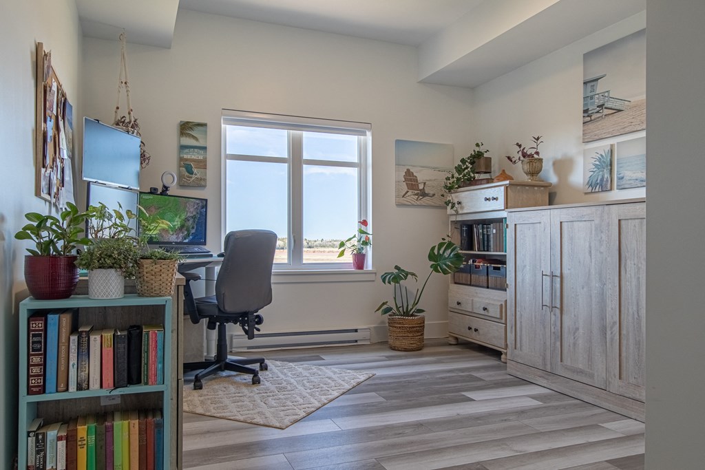 a home office with a desk and a window