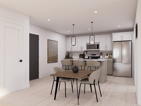 A modern kitchen with a dining table and chairs.